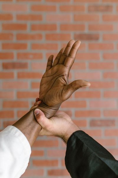 Close-up shot of hands in a stable position on a workout mat, showing focus and control.